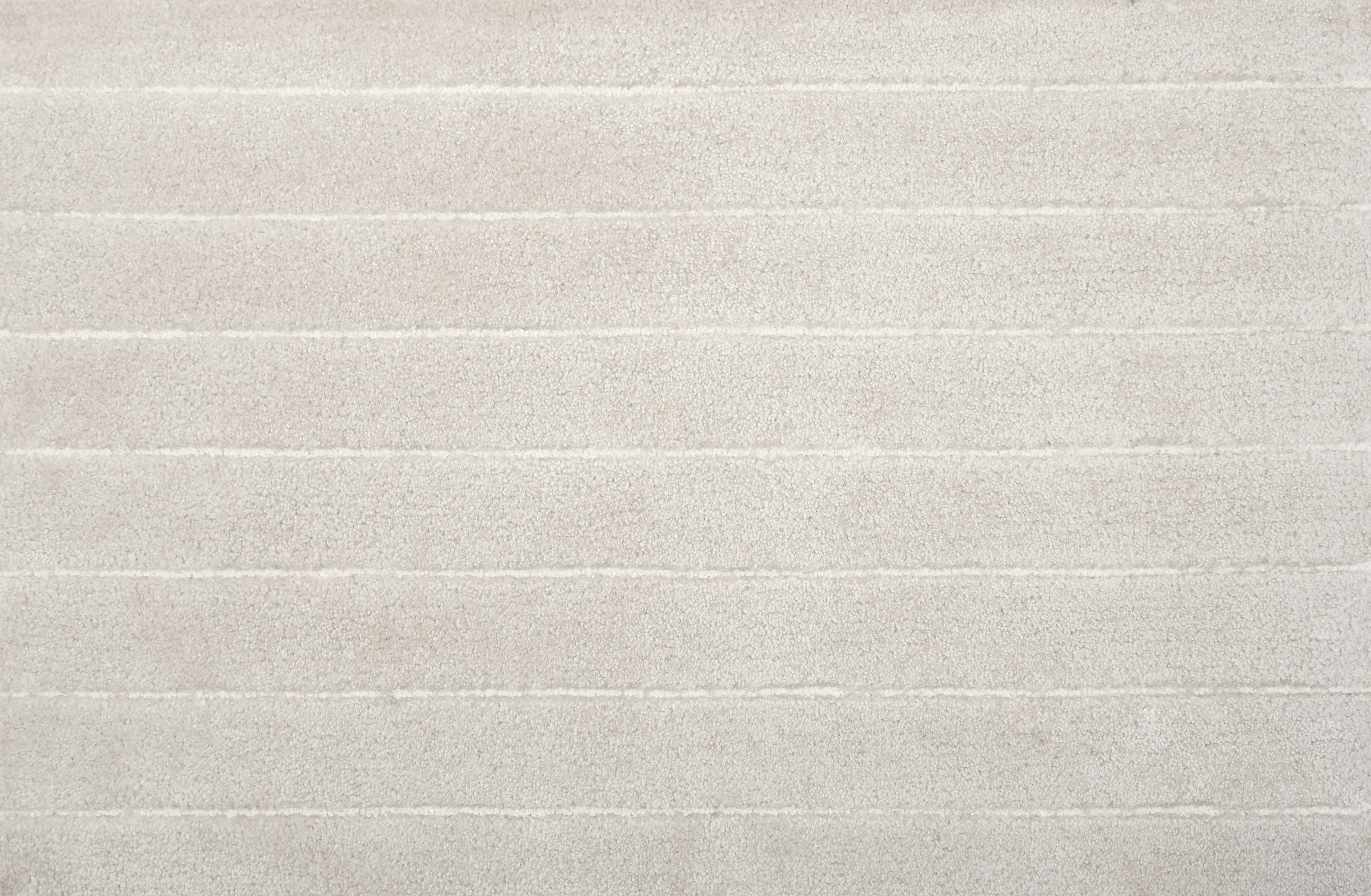 Broadloom carpet in a wide stripe pattern in tonal white. 