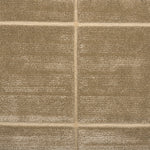 Textural performance broadloom carpet in grid design in tan.