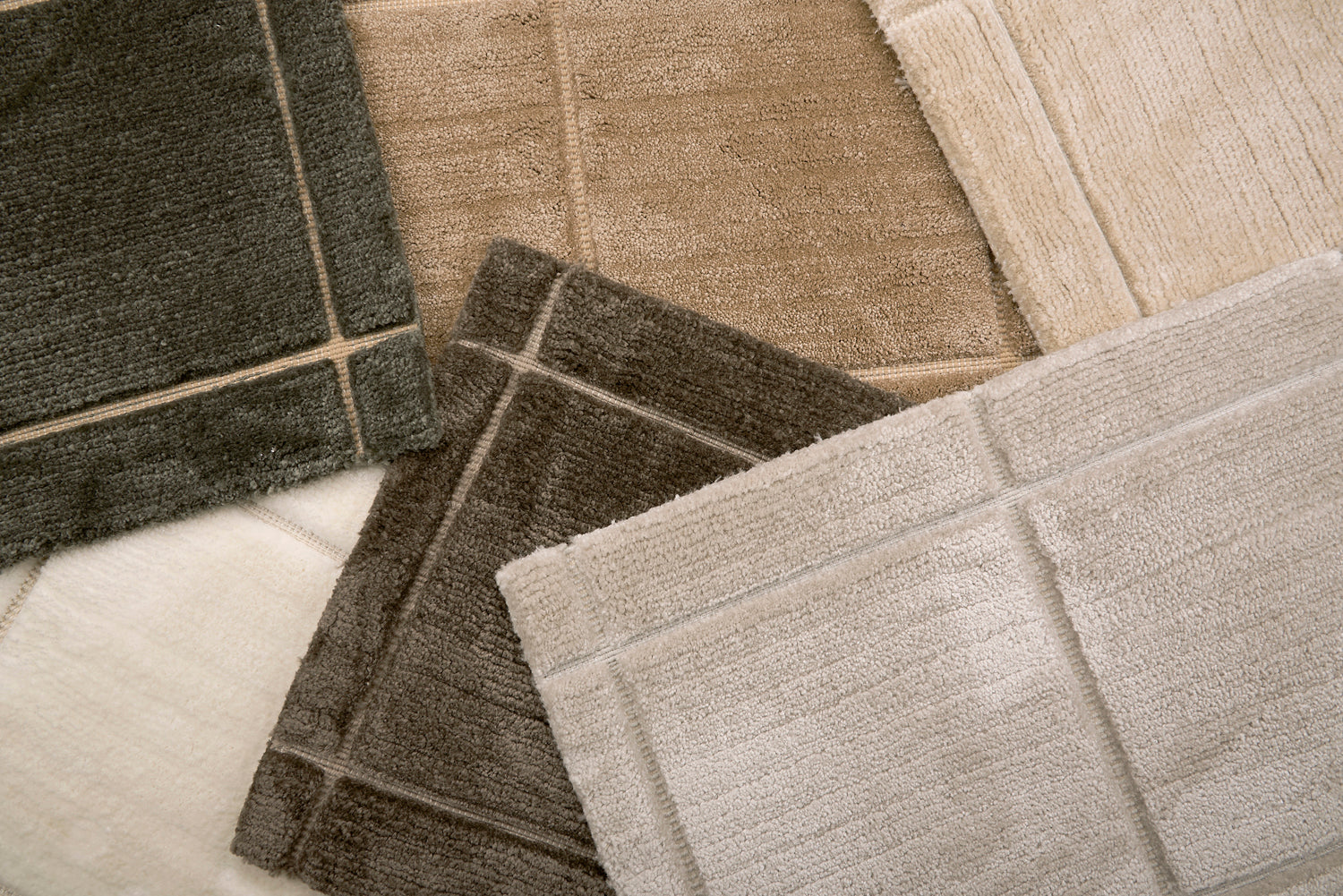 Pile of broadloom carpet samples in rich neutrals 