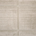 Textural performance broadloom carpet in grid design in beige.