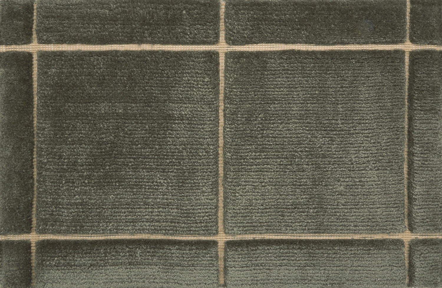 Textural performance broadloom carpet in grid design in dark green.