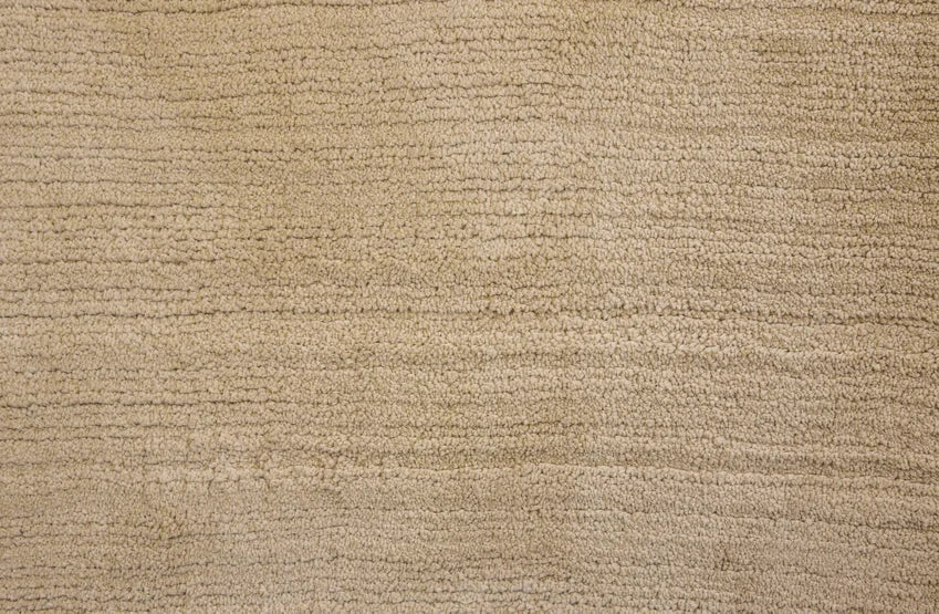 Broadloom carpet swatch in a solid pattern in a tan design