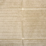 Textural performance broadloom carpet in grid design in tan.