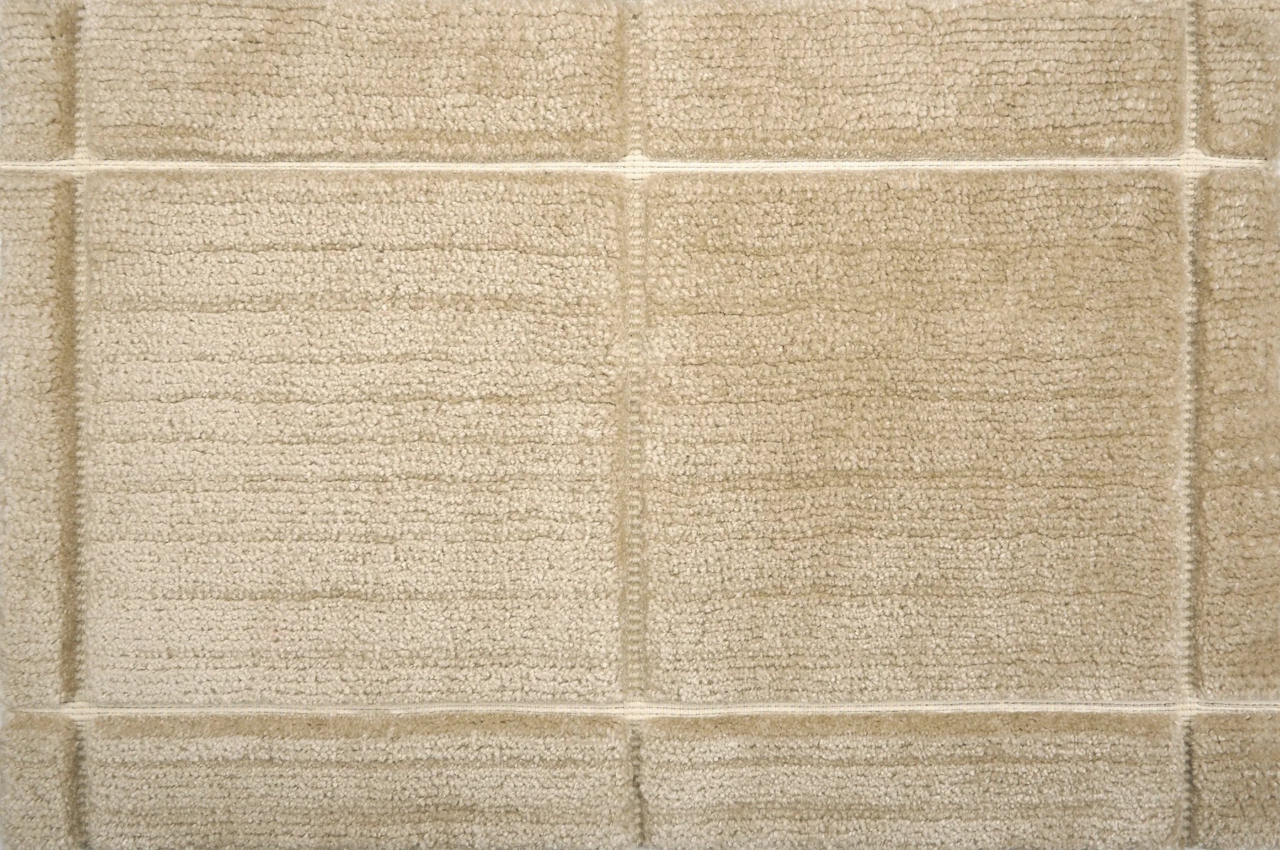 Textural performance broadloom carpet in grid design in tan.