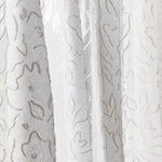 Draped sheer fabric in a hand drawn floral pattern in ivory.