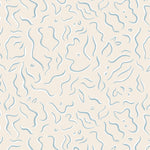 Detail of wallpaper in a painterly botanical print in light blue and white on a tan field.