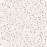 Detail of wallpaper in a painterly botanical print in light blue and white on a tan field.