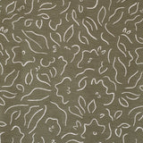 Detail of fabric in a minimalist floral print in cream on an olive field.