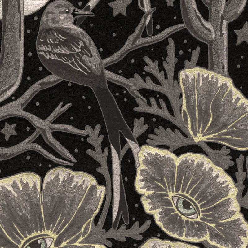 Detail of wallpaper in a statement desert print with a cactus, birds, flowers and moon. Colors are gray and tan.