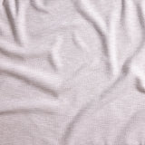Close up of gently draped woven Indoor-Outdoor fabric with basketweave texture in white.