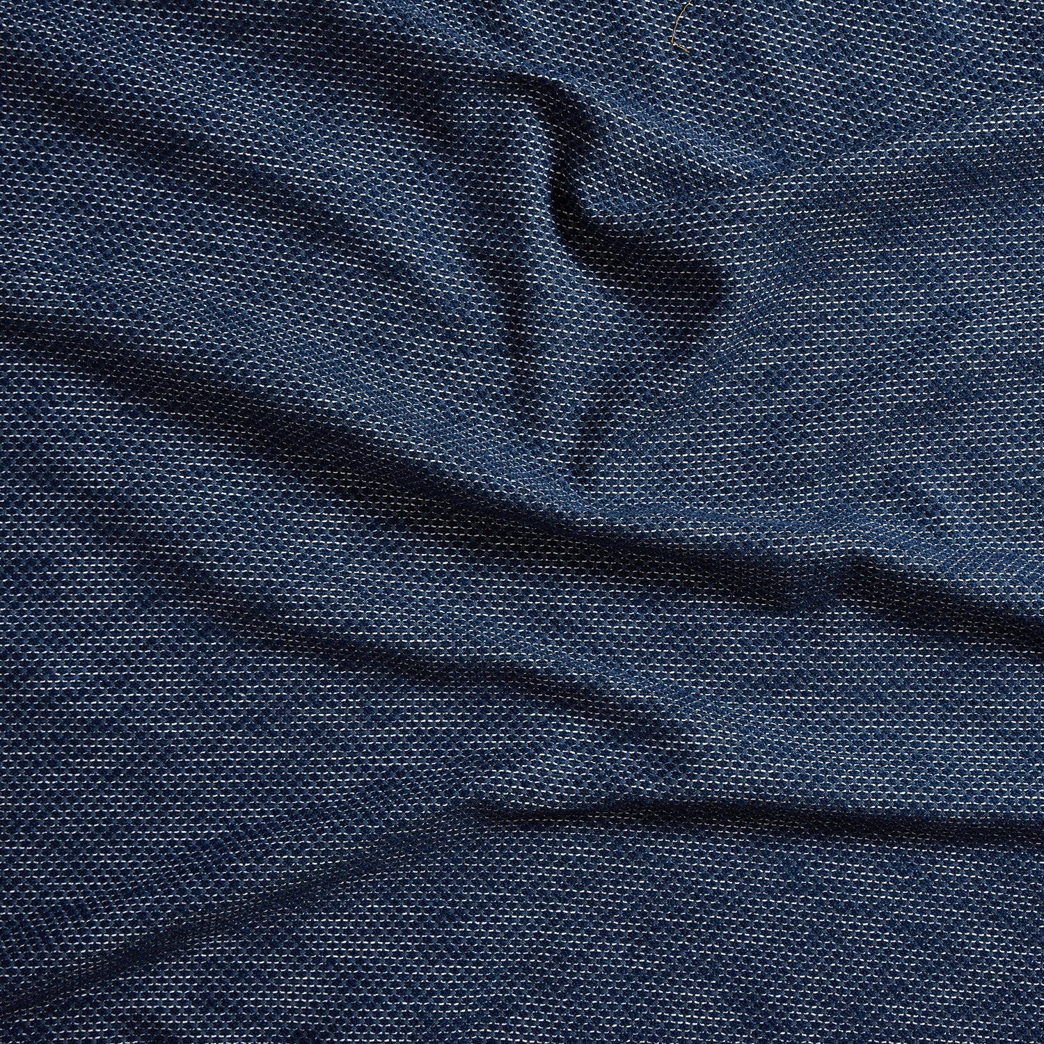 Close up of gently draped woven Indoor-Outdoor fabric with basketweave texture in navy blue and dark green.