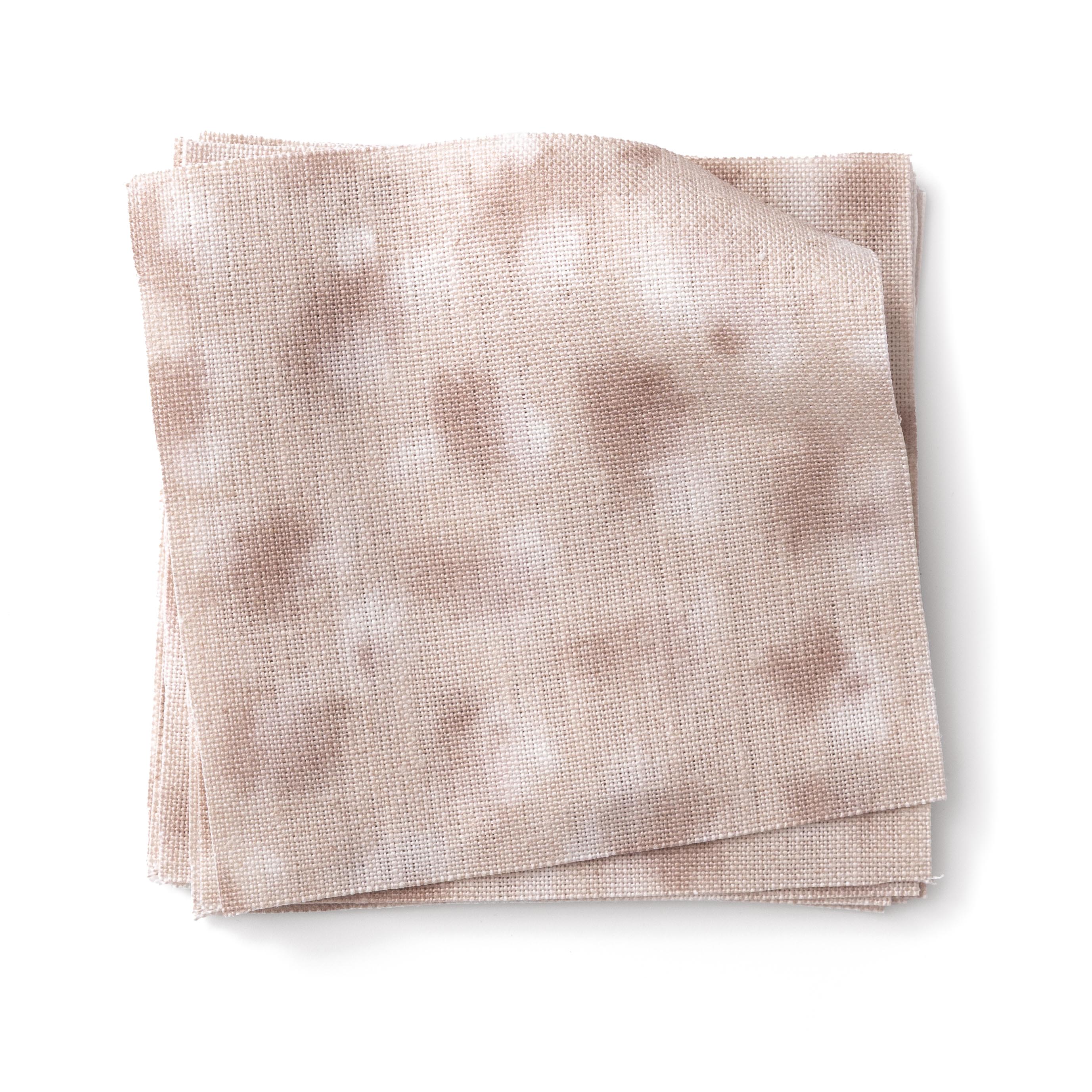 Stacked swatches of fabric in a painterly animal print in pastel pink with white accents. 