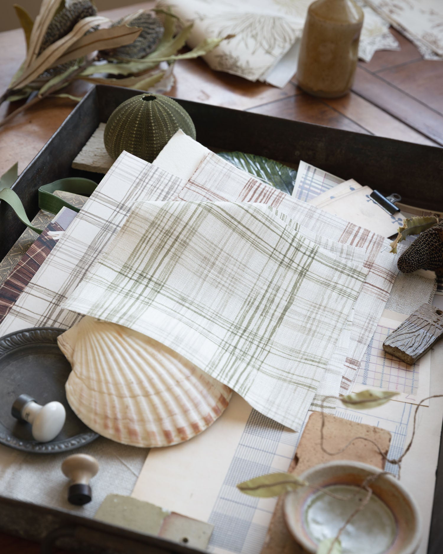 Desk setting with layered plaid printed fabrics with natural specimens 