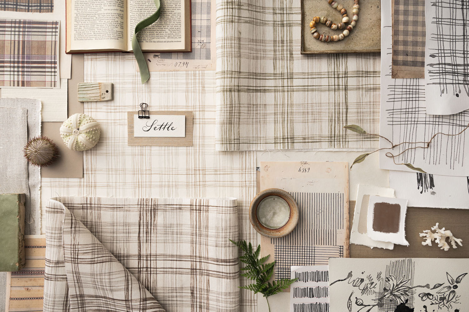 Collection of fabric swatches and decorative items on a neutral background
