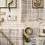 Collection of fabric swatches and decorative items on a neutral background