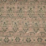 Handknotted rug with traditional floral motif in grey on a pink background. 