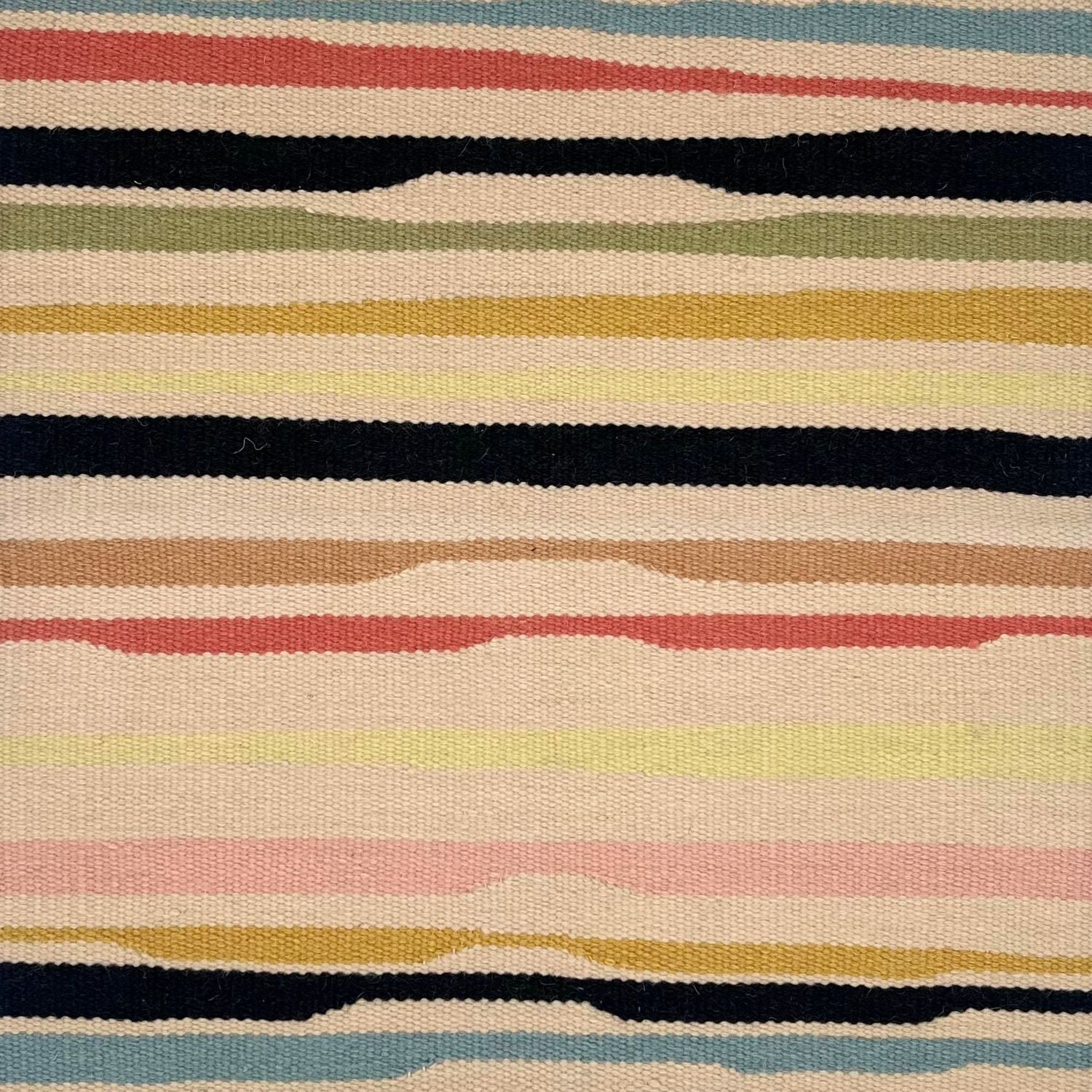 Detail of a flatwoven rug with a light tan ground and undulating stripes in medium blue, clay red, black, sage green, gold, tan, pale pink, and black.