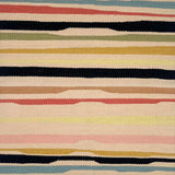 Detail of a flatwoven rug with a light tan ground and undulating stripes in medium blue, clay red, black, sage green, gold, tan, pale pink, and black.