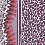 Detail of fabric in a bordered paisley print in shades of red, purple and white.