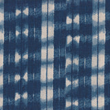Detail of fabric in a textural shibori print in shades of navy on a greige field.