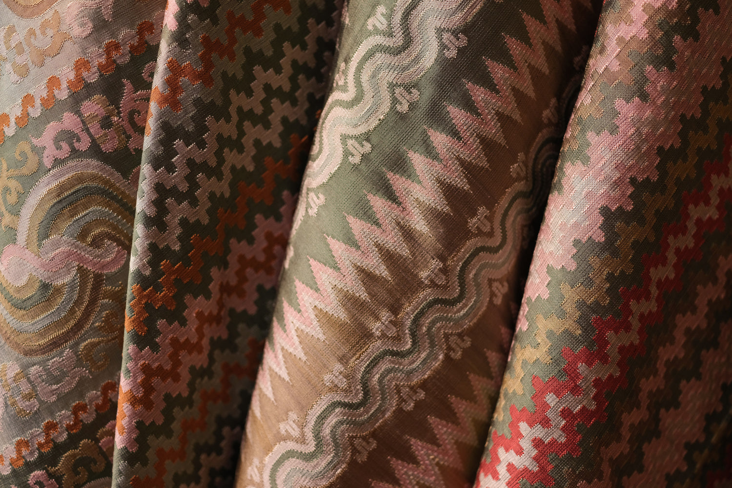 Close-up of patterned fabric with intricate designs in various colors.