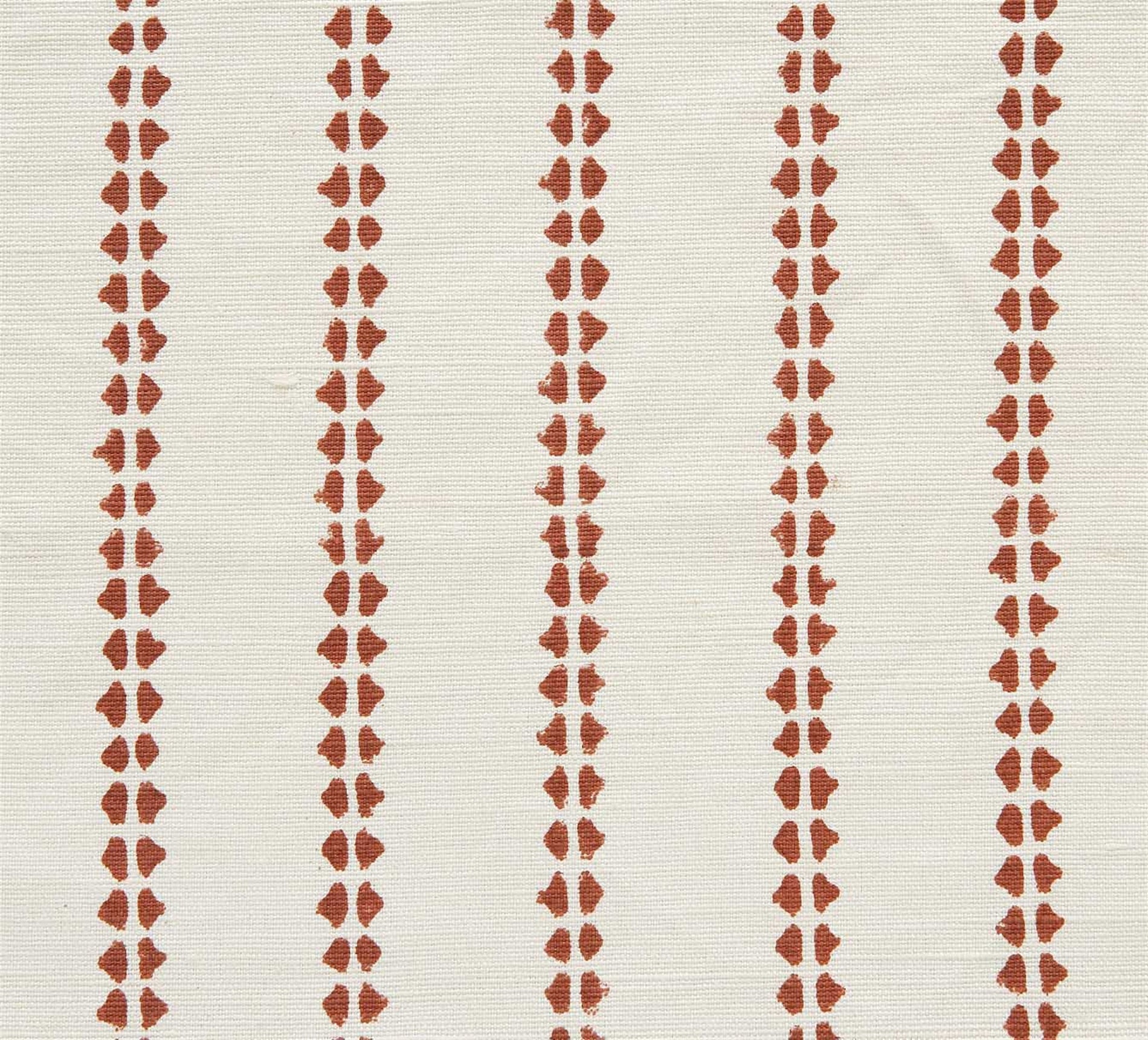 Detail of fabric in a playful ticking stripe print in rust on a white field.