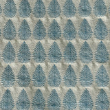 Detail of fabric woven in a repeating leaf print in shades of blue and gold.