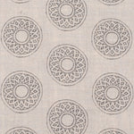 Detail of fabric in a repeating circular geometric print in gray on a cream field.