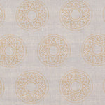 Detail of fabric in a repeating circular geometric print in yellow on a greige field.