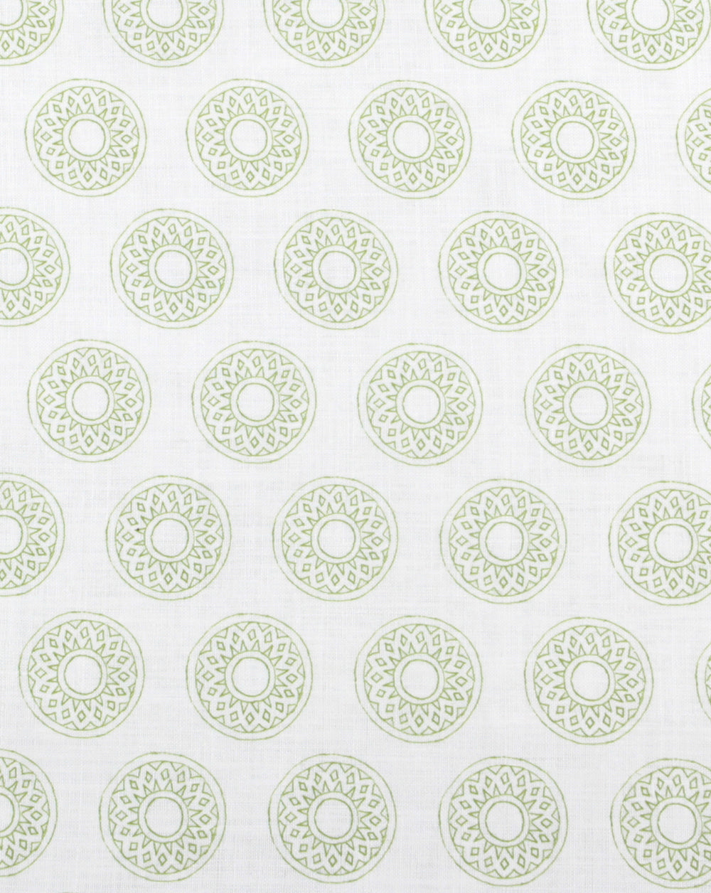 Detail of fabric in a repeating circular geometric print in green on a white field.