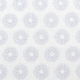 Detail of fabric in a repeating circular geometric print in light blue on a white field.