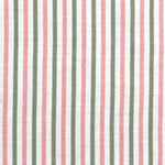 Detail of fabric in a small-scale stripe print in sage and pink on a white field.