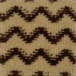 Close-up of a patterned carpet with black and beige zig zag design