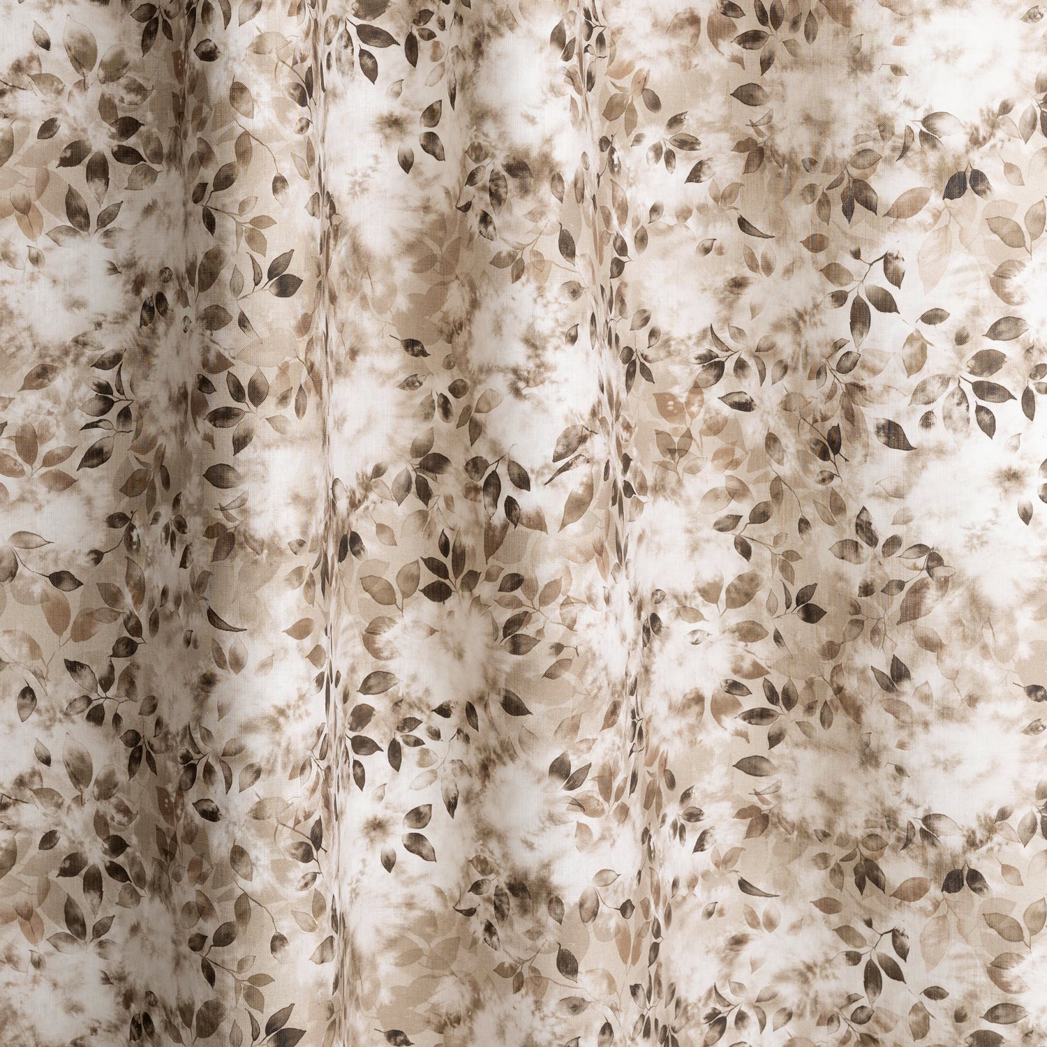 Gently draped fabric in a painterly leaf print in shades of brown and beige with a mottled white overlay.