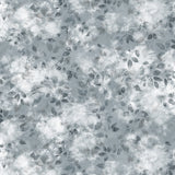 Detail of fabric in a painterly leaf print in shades of steel blue and teal with a mottled white overlay.