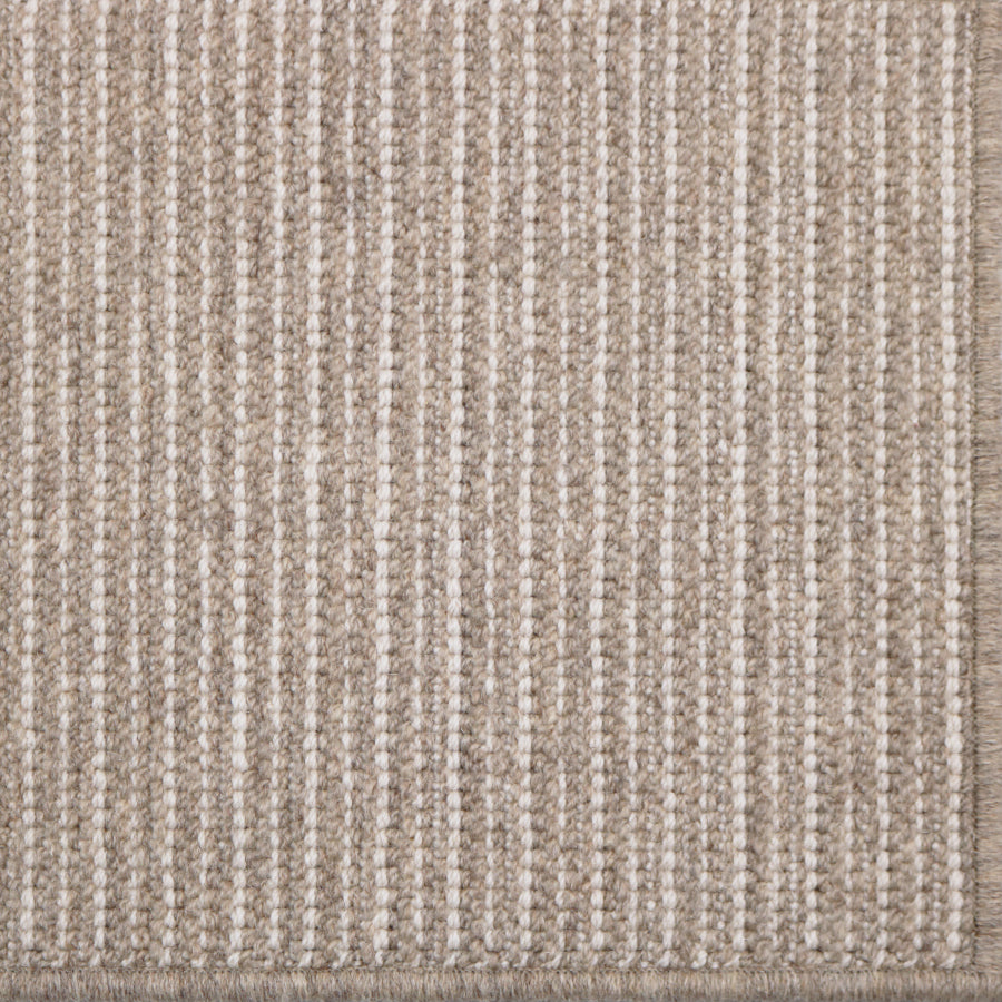 Close-up of a textured brown and beige rug with a subtle pattern