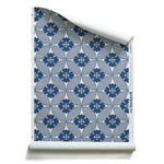 A roll of wallpaper featuring a Japanese inspired floral lattice design in navy blue on white. 
