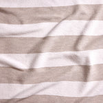Close up of gently draped woven Indoor-Outdoor fabric with wide textural stripes in white and taupe.
