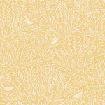 Detail of wallpaper in a playful bird and leaf print in white on a yellow field.