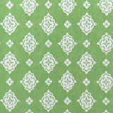 Detail of fabric in a floral damask print in white on a green field.