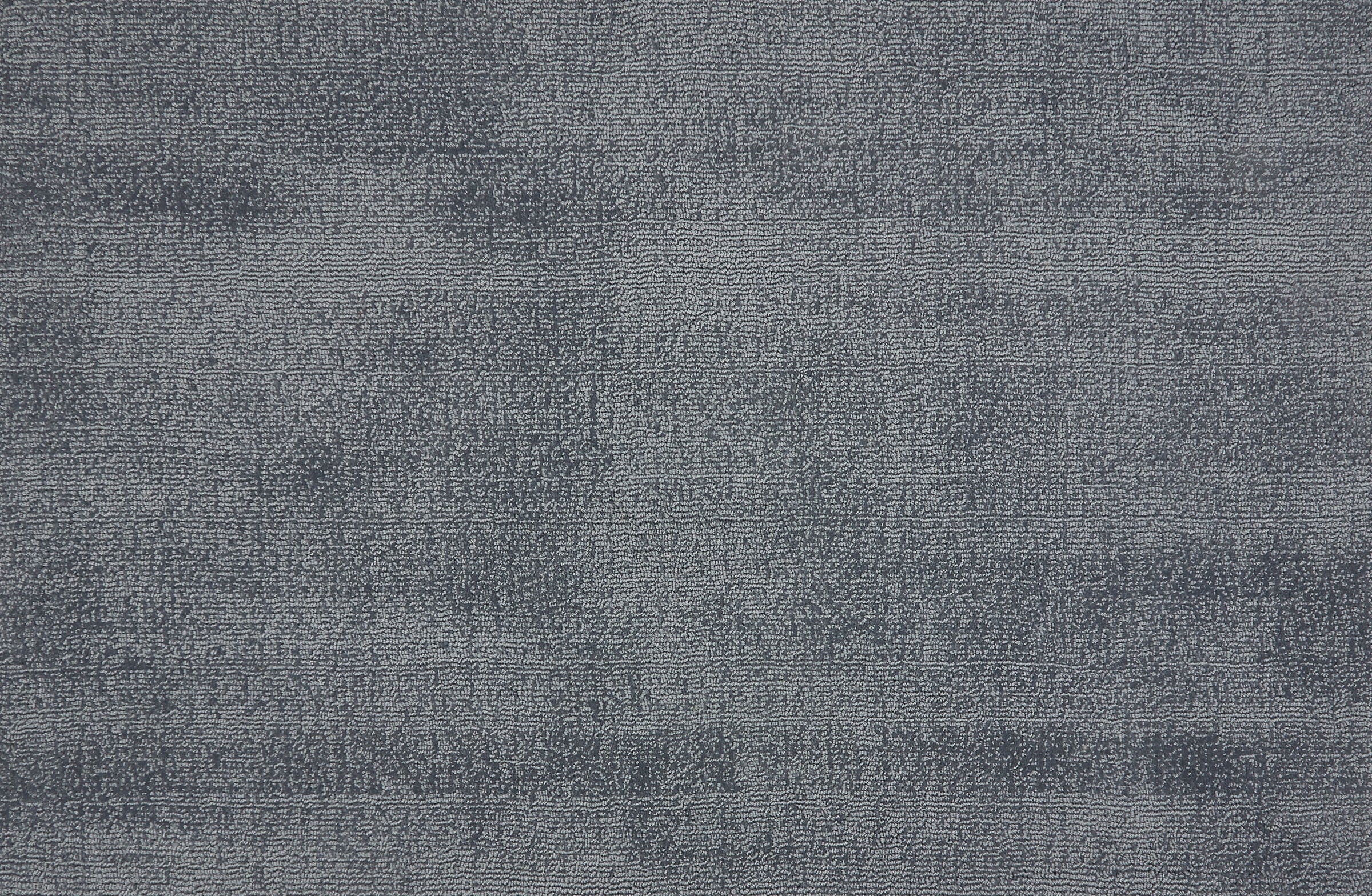 Broadloom carpet in a cut pile strié design in slate blue.