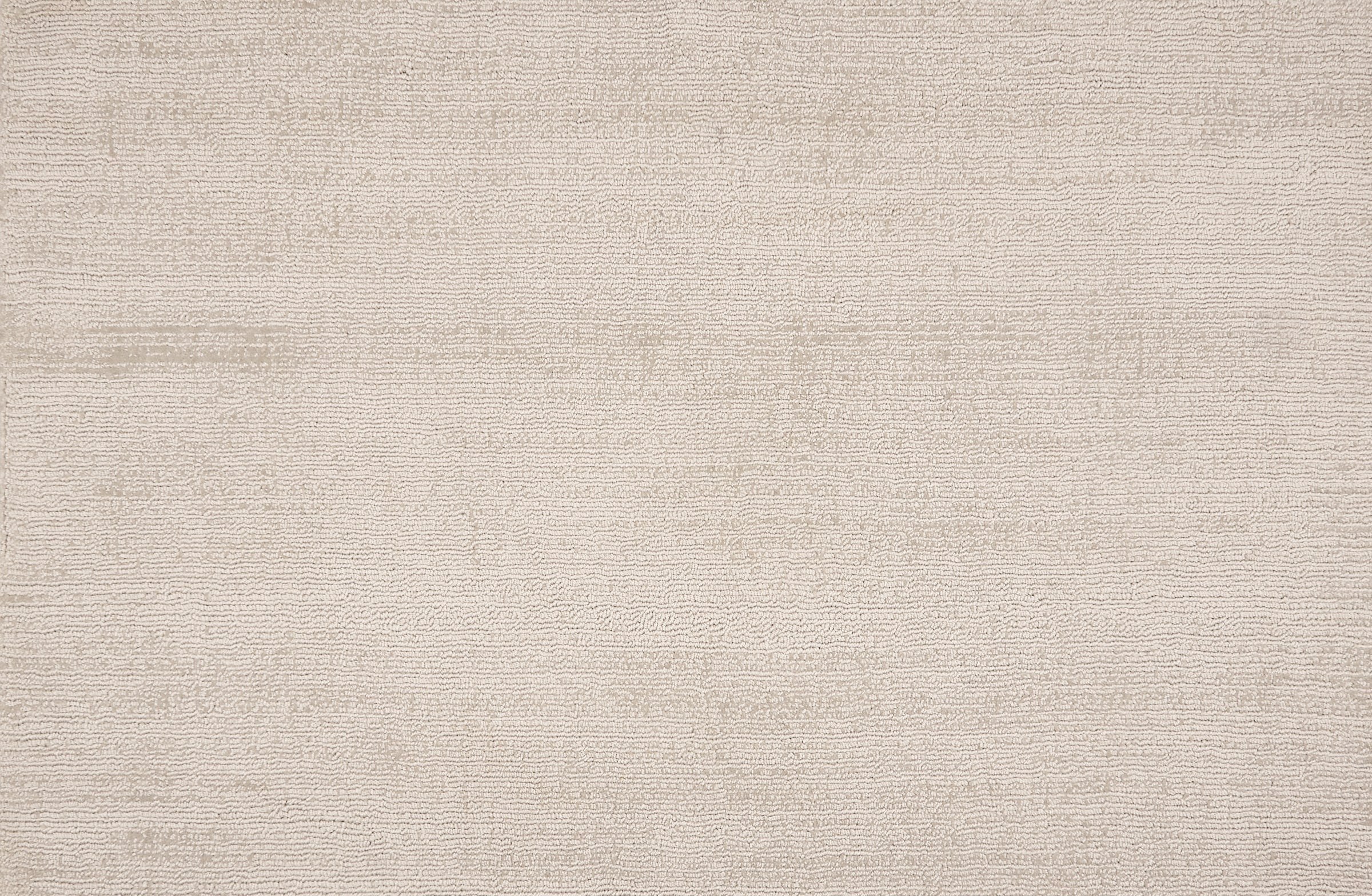 Broadloom carpet in a cut pile strié design in white.