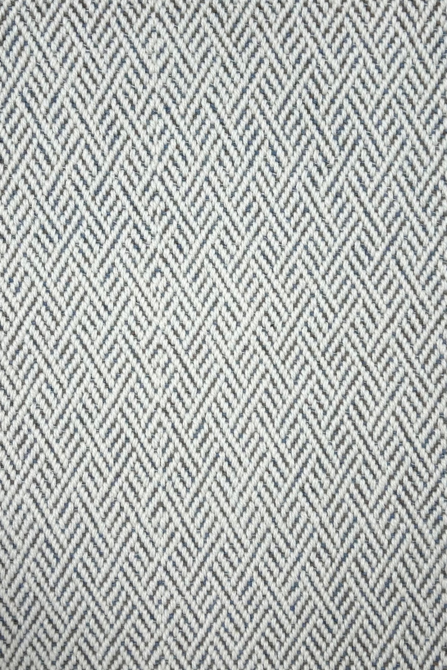 Broadloom carpet in a linear geometric design in blue and white. 