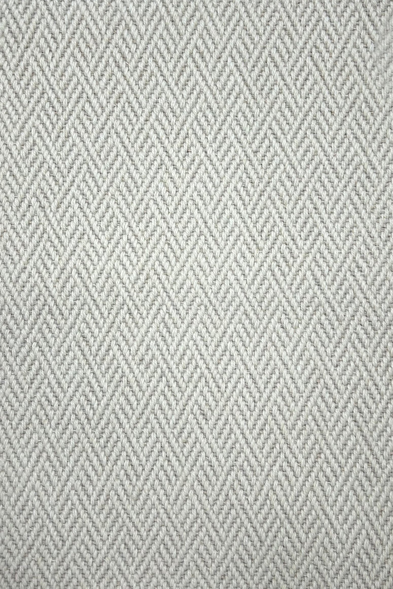 Broadloom carpet in a linear geometric design in light grey and white. 