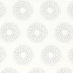 Detail of fabric in a repeating circular geometric print in light gray on a white field.
