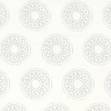 Detail of fabric in a repeating circular geometric print in light gray on a white field.