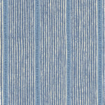 Detail of fabric in a repeating stripe and dash pattern in blue and navy on a cream field.