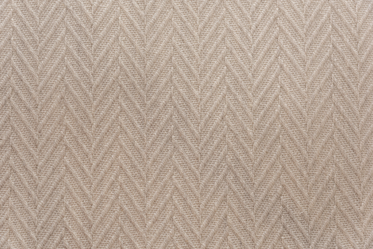 Broadloom carpet in a dimensional herringbone pattern in warm beige. 