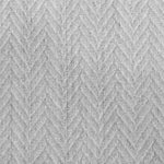 Broadloom carpet in a dimensional herringbone pattern in light grey. 