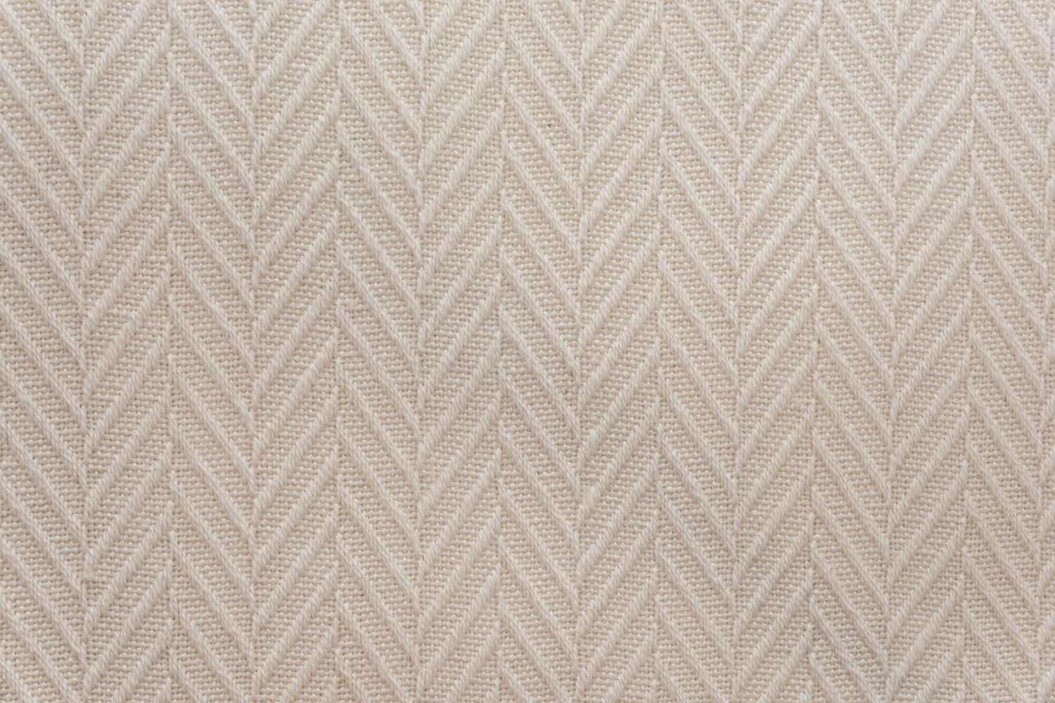 Broadloom carpet in a dimensional herringbone pattern in ivory. 